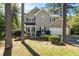 Inviting two-story home featuring neutral siding, dark shutters, and a well-maintained front yard at 1493 Martin Nash Sw Rd, Lilburn, GA 30047