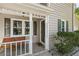 Charming porch with seating, dark shutters, and decorative white columns and railing at 1493 Martin Nash Sw Rd, Lilburn, GA 30047
