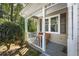 Charming front porch features neutral colors, a pair of chairs, and decorative columns at 1493 Martin Nash Sw Rd, Lilburn, GA 30047