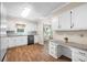 Well-lit kitchen featuring white cabinets, modern countertops, and stainless-steel appliances at 1493 Martin Nash Sw Rd, Lilburn, GA 30047