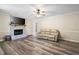 Spacious living room with a brick fireplace, modern flooring, and a cozy atmosphere at 1493 Martin Nash Sw Rd, Lilburn, GA 30047