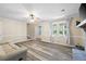 Well-lit living room with wood-look floors, brick fireplace, and natural light at 1493 Martin Nash Sw Rd, Lilburn, GA 30047