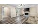 Living room featuring a brick fireplace, new flooring, and natural light from the windows at 1493 Martin Nash Sw Rd, Lilburn, GA 30047