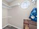 Organized walk-in closet with shelves and rod, plus a window for natural light at 1493 Martin Nash Sw Rd, Lilburn, GA 30047