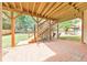Backyard patio with wood support beams and an open view of the green lawn at 1730 Millhouse Run, Marietta, GA 30066