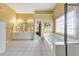 Spacious yellow bathroom featuring double sinks, soaking tub, separate shower and a window at 1730 Millhouse Run, Marietta, GA 30066