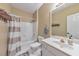 Bright bathroom with a white tub, shower with curtain, toilet, and a white sink and vanity at 1730 Millhouse Run, Marietta, GA 30066