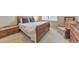Cozy bedroom featuring a sleigh bed, bench and padded window seat with neutral color carpet and walls at 1730 Millhouse Run, Marietta, GA 30066