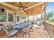 Covered deck with wood flooring, ceiling fans, and outdoor dining and seating areas at 1730 Millhouse Run, Marietta, GA 30066