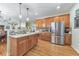 Open kitchen layout with stainless steel appliances and breakfast bar at 1730 Millhouse Run, Marietta, GA 30066