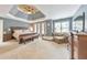 A main bedroom offers a tray ceiling, neutral walls, and a sitting area near the many windows at 1730 Millhouse Run, Marietta, GA 30066