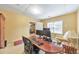 A home office with carpet flooring, natural light, and an adjacent living space at 1730 Millhouse Run, Marietta, GA 30066