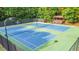 Well-maintained community tennis courts surrounded by lush greenery and trees, perfect for a friendly match at 1730 Millhouse Run, Marietta, GA 30066