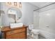 Charming bathroom with stylish vanity, round mirror, modern lighting, bathtub, and ceramic tile at 175 Fenwyck Commons, Fayetteville, GA 30214