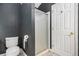 Cozy bathroom featuring a toilet and glass-enclosed shower, complemented by dark gray walls at 175 Fenwyck Commons, Fayetteville, GA 30214