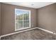 Neutral bedroom showcasing hardwood floors and a large window for natural lighting at 175 Fenwyck Commons, Fayetteville, GA 30214