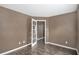 Bedroom showcasing neutral paint, hardwood floors, and an open french door leading to another room at 175 Fenwyck Commons, Fayetteville, GA 30214
