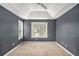 Carpeted bedroom with ceiling fan, neutral paint, and a large window for lots of natural light at 175 Fenwyck Commons, Fayetteville, GA 30214