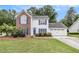 Charming two-story home with a brick accent and a well-manicured lawn at 175 Fenwyck Commons, Fayetteville, GA 30214