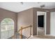 Landing featuring hardwood stairs, a large window, and access to the bedrooms at 175 Fenwyck Commons, Fayetteville, GA 30214