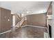 Spacious living room with dark wood floors, fireplace, and staircase at 175 Fenwyck Commons, Fayetteville, GA 30214