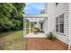 Outdoor patio with pergola, seating, and fire pit, nestled in a lush backyard at 175 Fenwyck Commons, Fayetteville, GA 30214