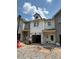 A modern, new construction townhouse showing the front exterior before landscaping is completed at 29 Benscot Dr, Austell, GA 30106