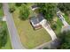 Aerial view of the property featuring a large lawn, back deck, and storage shed at 701 Rockingham Ct, Woodstock, GA 30189
