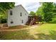Exterior of the home featuring a back deck and stone landscaping accents at 701 Rockingham Ct, Woodstock, GA 30189
