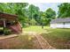 Spacious backyard with a patio, storage shed, and a rock garden feature at 701 Rockingham Ct, Woodstock, GA 30189