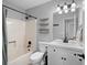 Bathroom features a shower/tub combo, single sink vanity and modern lighting at 701 Rockingham Ct, Woodstock, GA 30189