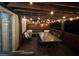 Outdoor deck with ample seating with a wood pergola and string lights at 701 Rockingham Ct, Woodstock, GA 30189