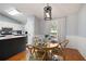 Bright dining area with hardwood floors and modern lighting that's perfect for entertaining at 701 Rockingham Ct, Woodstock, GA 30189