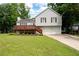 Charming two-story home with a well-maintained lawn, a wooden deck, and a two-car garage at 701 Rockingham Ct, Woodstock, GA 30189