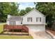 Charming home with a front deck, two-car garage, and well-maintained landscaping at 701 Rockingham Ct, Woodstock, GA 30189