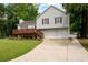Two-story home with a deck, two-car garage, driveway and landscaped front lawn at 701 Rockingham Ct, Woodstock, GA 30189