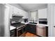 Kitchen features stainless steel appliances, and white and black cabinets at 701 Rockingham Ct, Woodstock, GA 30189