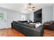 Spacious living room with hardwood floors, fireplace, ceiling fan, and comfortable seating at 701 Rockingham Ct, Woodstock, GA 30189