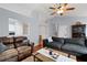 Well-lit living room with hardwood floors, comfortable seating, and staircase at 701 Rockingham Ct, Woodstock, GA 30189