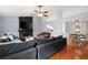 Open-concept living room with hardwood floors, fireplace, and a dining area with natural light at 701 Rockingham Ct, Woodstock, GA 30189
