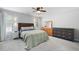 Spacious bedroom featuring multiple dressers, ceiling fan, carpet, and natural light at 701 Rockingham Ct, Woodstock, GA 30189