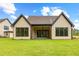 Spacious backyard featuring a covered patio and large windows at 210 Regester Way, Peachtree City, GA 30269