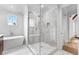 Bright bathroom with marble floors, a standalone tub, and a glass-enclosed shower with white tiles at 210 Regester Way, Peachtree City, GA 30269
