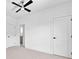 Bedroom featuring neutral carpet, ceiling fan, and access to a bathroom at 210 Regester Way, Peachtree City, GA 30269