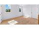 Sunlit bedroom with hardwood floors and two windows at 210 Regester Way, Peachtree City, GA 30269