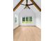 Bright bedroom with vaulted ceilings, wooden beams, and large windows overlooking the yard at 210 Regester Way, Peachtree City, GA 30269