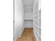 Well-organized walk-in closet with custom shelving and wooden floors at 210 Regester Way, Peachtree City, GA 30269