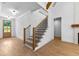 Bright entryway with a modern staircase, wooden floors, and abundant natural light at 210 Regester Way, Peachtree City, GA 30269