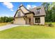 Charming home with a stone facade, manicured lawn and stylish architectural details, located in a quiet residential area at 210 Regester Way, Peachtree City, GA 30269