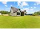 New home featuring a charming covered patio and scenic lawn at 210 Regester Way, Peachtree City, GA 30269